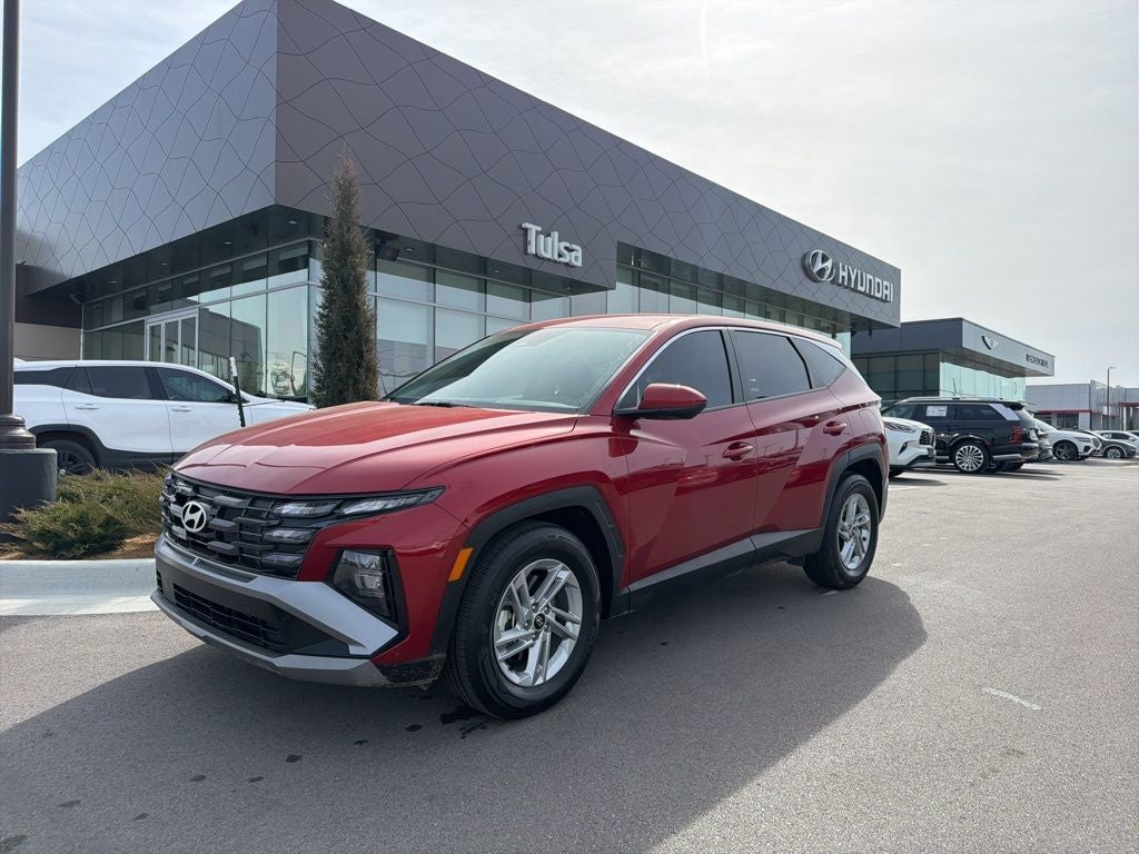 2026 Hyundai TUCSON SE in Ultimate Red — front three-quarter view